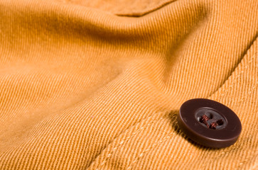 clothing items stonewashed cotton fabric texture with seams, clasps, buttons and rivets, macro