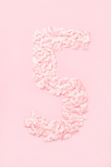 Number five collected from decorative pink hearts. Isolated on pink background