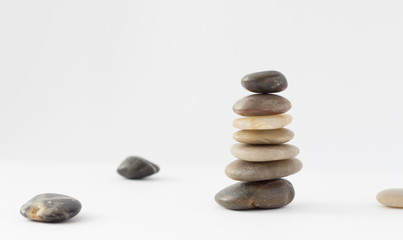 Balance, peace of mind, stones form a pyramid on a white surface