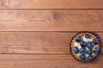 fruit tartlet on  the wooden table, fruit baked shell, fruit cupcake with berry