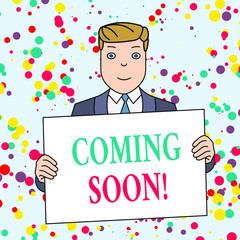 Text sign showing Coming Soon. Business photo showcasing event or action that will happen after really short time Smiling Man Holding Formal Suit Big Blank Poster Board in Front of Himself