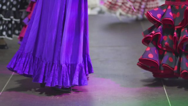 Spain - Flamenco. Women in traditional dresses dancing flamenko.