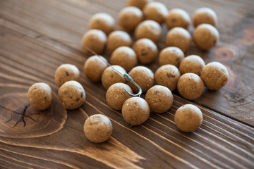 Carp baits on a wooden background.