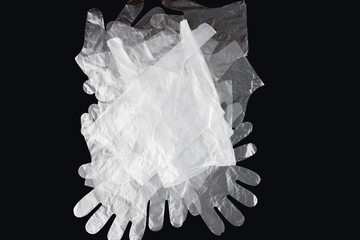 Plastic bag with handles, gloves, on a black background . Used plastic bag for recycling. Concept -...