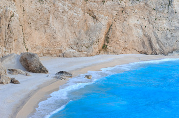 Top view of a beach with cyan blue water and rock. World ocean day