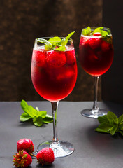 Refreshing drink with strawberries and mint on a table. Perfect for party or hot days.	