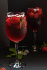 Refreshing drink with strawberries and mint on a table. Perfect for party or hot days.	