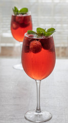 Refreshing drink with strawberries and mint on a table. Perfect for party or hot days.	