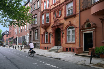 Fototapeta na wymiar urban street with old brownstone style townhouses or apartment buildings