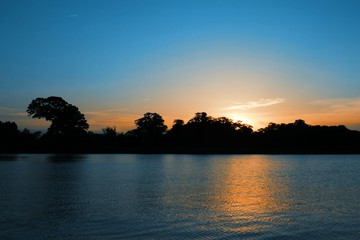 Sunset during Summer Evening with Sunlight Reflecting against the Water