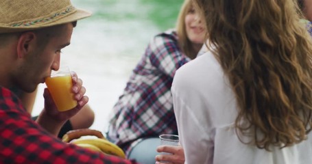 Happy millennial friends cheering at breakfast brunch meal in nature outdoor