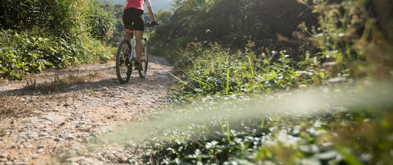 Woman cyclist riding a bike on a nature trail in the mountains.people living a healthy lifestyle