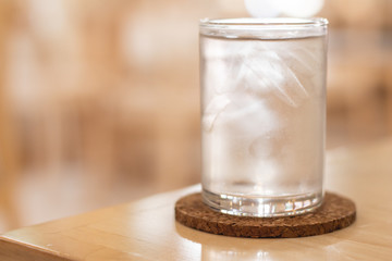 Close up of Cold water with ice on table.