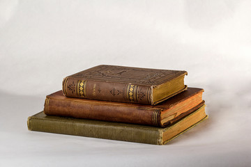 Stack of Three Antique books on a white background.