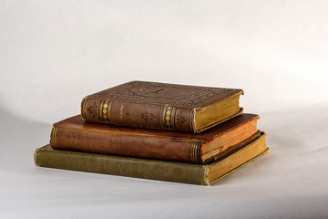 Stack of Three Antique books on a white background.