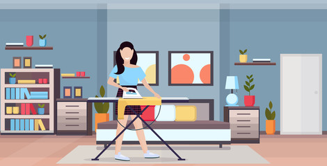 housewife ironing clothes young woman holding iron smiling girl doing housework concept modern bedroom interior female cartoon character full length flat horizontal vector illustration