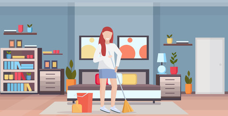 housewife holding broom woman cleaner doing housework sweeping floor cleaning housekeeping concept full length flat modern bedroom interior horizontal