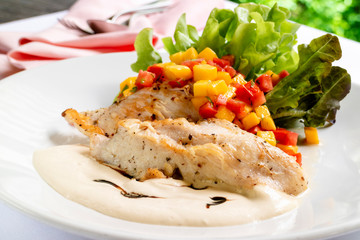 Gill chicken breast in white sauce with fresh mango cut, fresh queen tomato and green vegetable salad.