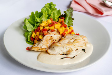 Gill chicken breast in white sauce with fresh mango cut, fresh queen tomato and green vegetable salad.