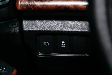Naklejka premium Сlose-up of the car black interior: off road, assistance during the descent from the mountain and other buttons
