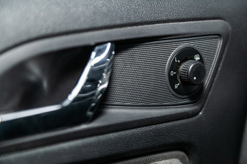 Interior design of the modern car: window adjustment buttons, door lock. luxury prestige car interior.