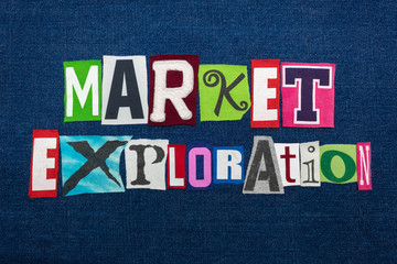 MARKET EXPLORATION text word collage, multi colored fabric on blue denim, new markets concept, horizontal aspect