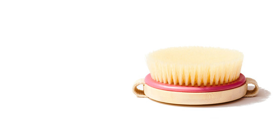 Dry body massage brush on white background at sunny day. Tool for smooth and soft skin. Place for text.