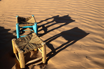 Chairs sitting in the Sahara Desert in a camp