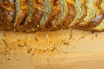 Slice Brioche toast loaf with bread crumbs on wood cutting board, bakery or breakfast concept.