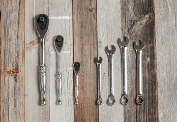 Tools, set wrenches on a wood background
