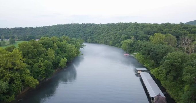 Drone footage hovering over a foggy river.