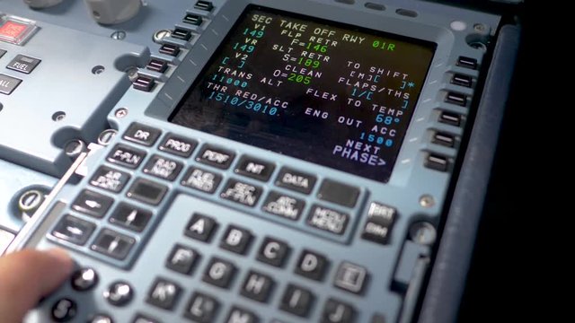 Hand of pilot input some flight parameters Airbus A319 A320 A321,preparing flight on ground.