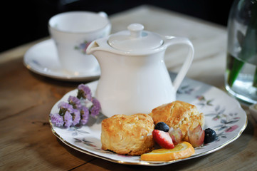 scone with fruit and  teapot
