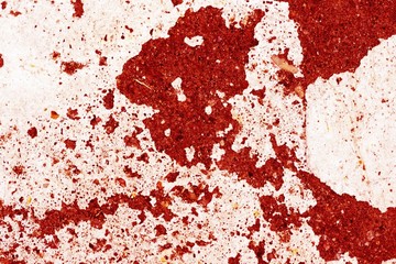 Old asphalt surface painted with white paint close up. Abstract background red color toned