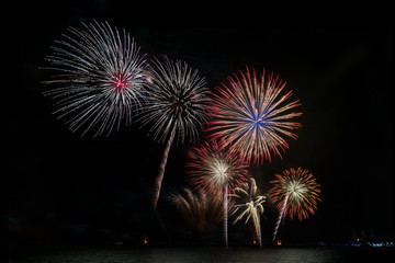 Colorful fireworks of various colors at night with celebration and anniversary concept