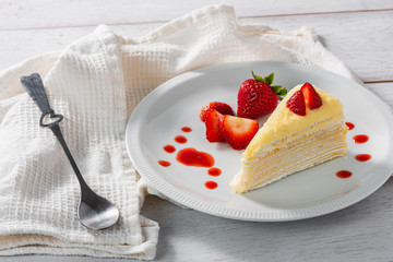 piece of strawberry cake dessert and sauce topping on white dish