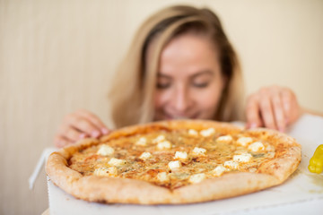 Portrait of a woman eating pizza. Beautiful young woman in black underwear eating pizza