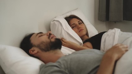 Couple with snoring problem concept, Woman has problem form her husband snoring while sleeping on bed