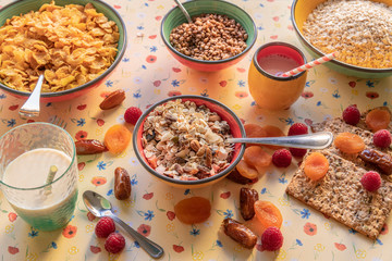 Healthy and nutritious breakfast with mixed raisins, corn, oatmeal and milk.