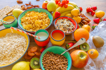 Fototapeta na wymiar Orange juice, milk, cereals and fruits for breakfast