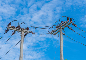 The electric pole and electric transformer with cloud blue sky