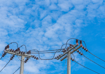 The electric pole and electric transformer with cloud blue sky