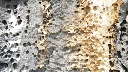 Texture of natural stone. Modern background. Image. Design for poster. Abstract backdrop. Black, grey, biege, sepia. Hole on the surface. Patterns and textures of rocks in nature. Closeup detail stone