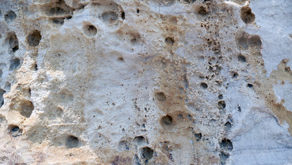 Texture of natural stone. Modern background. Image. Design for poster. Abstract backdrop. Black, grey, biege, sepia. Hole on the surface. Patterns and textures of rocks in nature. Closeup detail stone