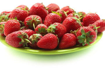 Heap of strawberries in green plate