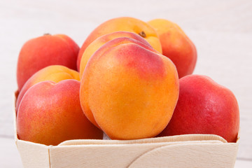 Fresh apricot in wooden box as healthy snack or dessert containing vitamins