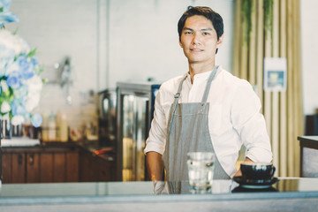 service staff or owner standing in coffee shop