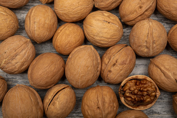 a scattering of walnuts on a wooden background close-up