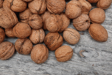 a scattering of walnuts on a wooden background close-up