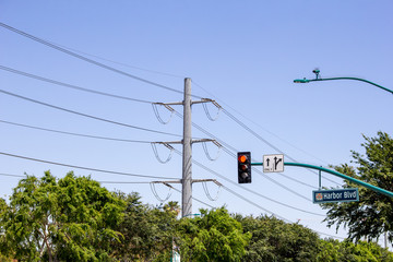 Large metal utility poles bring in lots of electricity to the nearby part of town